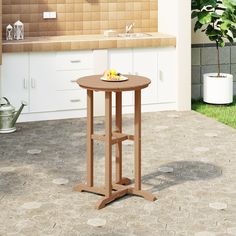 a small table in the middle of a patio with a potted plant on it