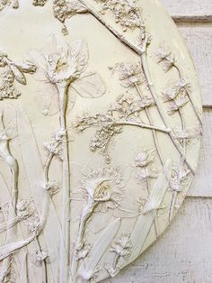 a white plate with flowers and branches on it