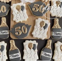 decorated cookies are arranged in the shape of wine bottles and 50th anniversary gifts for someone special