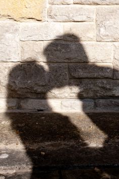 the shadow of a person holding a cell phone