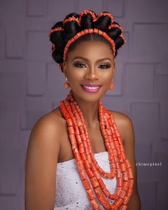 an african woman with braids and orange beads