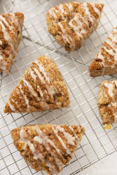 several pastries on a cooling rack with icing drizzled over them