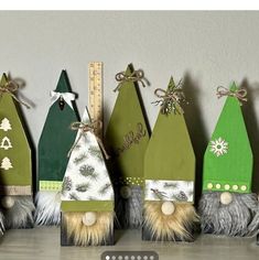 a row of wooden christmas trees sitting on top of a table