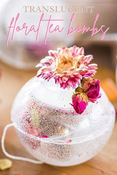 a vase filled with flowers on top of a wooden table