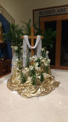 a cross and flowers on display in a church