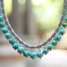 This breathtaking statement necklace is the creation of Bali's Zayd Makarim. Tubular sterling silver beads all decorated with Makarim's signature 'Buddha's curl' motif are strung on a thick sterling chain. Each bead is adorned with a dangling bauble of sky-blue reconstituted turquoise. The substantial necklace is secured by an ornate push-button clasp. Cheap Vintage Necklaces With Silver Beads, Cheap Oval Beads Jewelry For Festivals, Silver Bohemian Turquoise Necklace For Festivals, Bohemian Silver Turquoise Necklace For Festivals, Turquoise Necklace With Silver Round Beads, Bohemian Jewelry With Intricate Design And Round Beads, Bohemian Jewelry With Intricate Round Beads, Handmade Silver Turquoise Necklace For Festivals, Adjustable Silver Turquoise Necklace In Spiritual Style