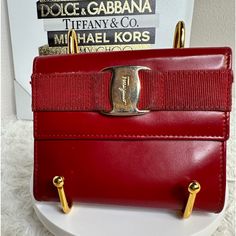 100% Authentic. Preloved With No Major Flaws. Very Light Signs Of Use. No Box Or Dust Bag. Measurements: 4.25in L 3.5in H X Tin W Formal Red Box Bag With Gold-tone Hardware, Red Evening Bag With Gold-tone Hardware, Red Rectangular Satchel With Gold-tone Hardware, Elegant Red Clutch With Gold-tone Hardware, Salvatore Ferragamo Bags, Luxury Red Shoulder Bag With Gold-tone Hardware, Compact Wallet, Bag Measurements, Lighted Signs