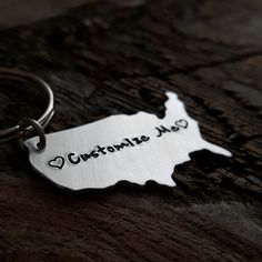 a metal keychain with the word customize me on it