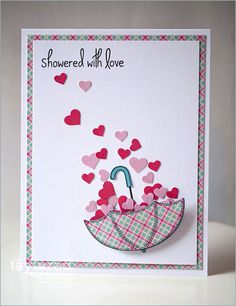 a card with an umbrella and hearts on it