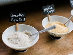 three small bowls filled with different types of salt and seasoning next to each other