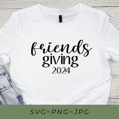 a white shirt with the words friends giving on it next to jeans and a pair of shoes