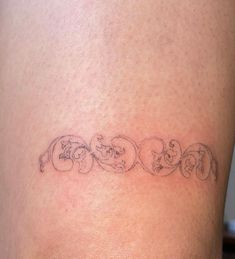 a woman's lower back tattoo with three elephants on her left thigh and the word love written in cursive font