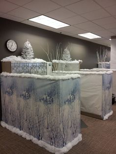 an office cubicle decorated with snow and trees