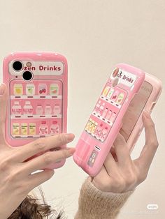 a woman holding up a pink cell phone case that has an image of a drink machine on it