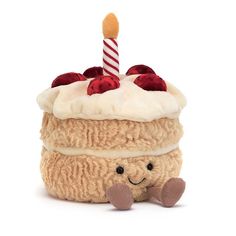 a stuffed animal with a birthday cake on it's head and a candle sticking out of its top