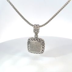 Vintage John Hardy Classic Chain Pendant with Pave Diamonds in Sterling Silver. This Statement Necklace Packs a Punch of Personality Into One Piece of Jewelry. With Fantastic Texture and Presence, featuring John Hardey's Classic Chain Motif with Deep Woven Texture. Finished with Pave Diamonds this Piece Can Easily Go From Day to Night. 16 Inch Chain 0.9 inch square pendant 22.2 Grams Stamped Sterling Silver Diamonds Approximately 0.85 cttw Luxury Engraved Diamond Necklace For Formal Occasions, Luxury Wheat Chain Jewelry, Classic Silver Diamond Necklace With Box Chain, Formal Silver Diamond Necklace With Box Chain, Silver Diamond Necklace With Box Chain For Formal Events, Silver Diamond Necklace With Box Chain For Formal Occasions, Designer Silver Diamond Necklace, Designer Silver Diamond Necklaces, Designer Silver Jewelry With Pave Setting