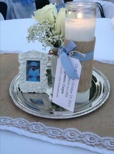 there is a candle and some pictures on the table with tags attached to each one