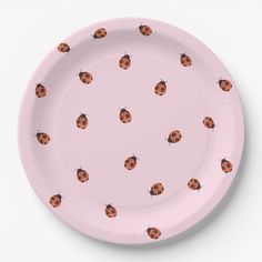 a pink paper plate with ladybugs on the front and sides, all over it