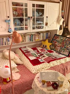 a bed with a red and white checkered bedspread on top of it