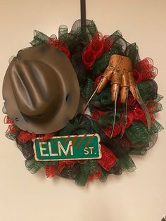 a hat, glove and mesh wreath with the name elm st on it