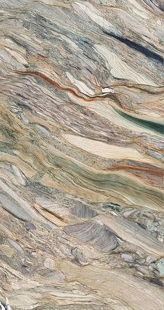 a marble counter top with different colors and patterns on it's surface is shown in this image