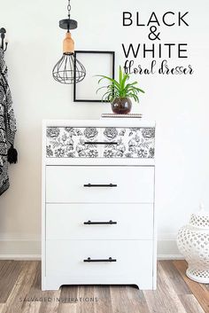 a white dresser with black and white designs on it