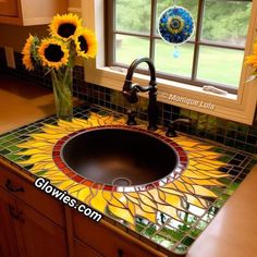 a kitchen sink with sunflowers on the counter