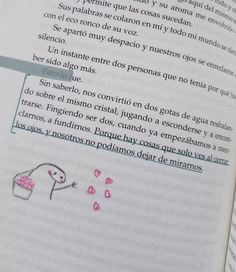 an open book with pink writing on the page and a drawing of a cupcake