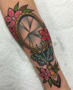 a woman's leg with a tattoo on it and a clock in the middle