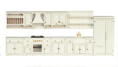 the model kitchen is white and has gold trimmings on the cabinets, drawers, and stove