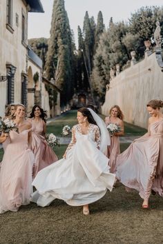 a bride and her bridal party walking down the street