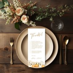 a place setting with flowers, silverware and a menu card on the plate that says thank you