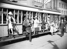 an old black and white photo of people boarding a train