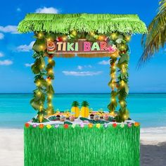 a tiki bar on the beach decorated with lights and palm trees for an outdoor party