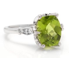 3.00 Carats Impressive Natural Peridot and Diamond 14K White Gold Ring Suggested Replacement Value: Approx. $2,000.00 Total Natural Peridot Weight is: Approx. 2.92 Carats Peridot Measures: Approx. 10.00 x 8.00mm Natural Round Diamonds Weight: Approx. 0.08 Carats (color G-H / Clarity SI1-SI2) Ring total weight: Approx. 4.0 grams Disclaimer: all weights, measurements and colors are approximate and may vary slightly from the listed dimensions or as seen in the image. All pictures are magnified to s Classic Peridot Diamond Ring, Classic Peridot Gemstone Diamond Ring, Formal Peridot Diamond Ring With Center Stone, Elegant Lime Green Rings For Anniversary, Formal Green Diamond Ring With Gemstone Accents, Green Diamond Ring With Gemstone Accents For Formal Occasions, Formal Peridot Diamond Ring With Prong Setting, Classic Wedding Diamond Ring With Peridot, Elegant Lime Green Formal Ring