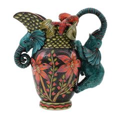 an elephant shaped vase with flowers and birds on it's back legs, painted in black