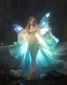 a woman dressed as a fairy with blue wings