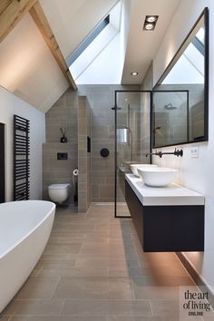 a bathroom with a skylight and two sinks in the center of the bathtub