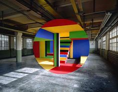 an art installation in the middle of a large room with multiple colored walls and floors