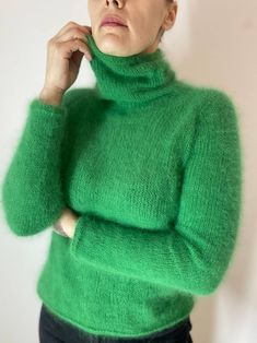 Stay cozy and stylish in this luxurious green angora wool sweater with a chic high collar. Handcrafted with the finest quality angora wool, this sweater is soft, warm, and perfect for chilly days. The timeless design and classic color make it a versatile piece for any wardrobe. green turtleneck look at the photo of flowers and choose which one you like. The color plate is shown in the photo. I offer a choice of 27 colors! The sweater in the photo is made in color No.10 If you did not find the co Fitted Mohair Turtleneck Sweater, Green Mohair Knitted Sweater, Green Funnel Neck Winter Sweater, Green Funnel Neck Sweater For Winter, Green Mohair Cozy Sweater, Elegant Green Winter Sweater, Cozy Green Mohair Sweater, Green Mohair Winter Sweater, Fitted Green Hand Knitted Sweater