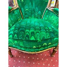 a green chair sitting on top of a red carpet