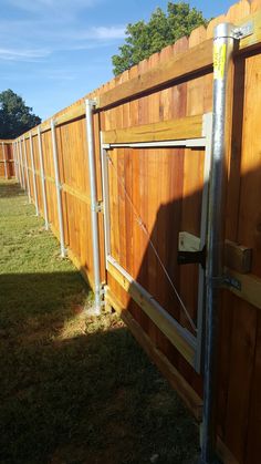 a wooden fence with metal poles attached to it