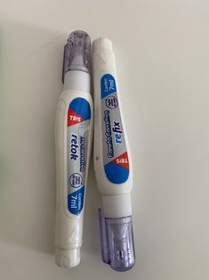 two toothbrushes sitting next to each other on a table