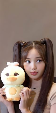 a woman holding a stuffed animal in her hands