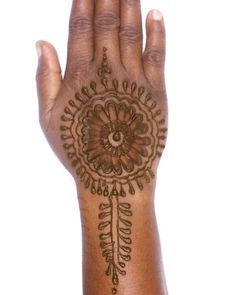 a woman's hand with henna tattoos on it