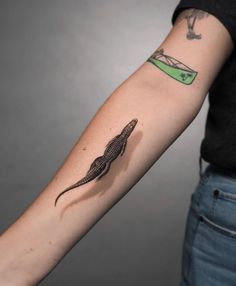 a person with a lizard tattoo on their arm