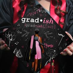 a woman in a graduation gown holding a black cap with the words grad ish on it