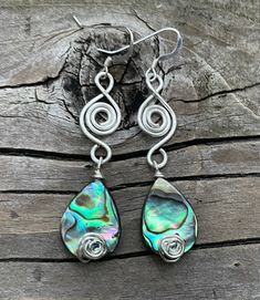 These silver wire wrapped abalone shell earrings are really beautiful. Not only are they super lightweight, they have a very unique wire wrapped swirl design made with silver wire. These earrings  are 2 inches long and a half inch wide. Earwires are Sterling silver. All my jewelry comes gift boxed with a custom Shelly Mariposa Design butterfly card ready for gift giving, whether it is a gift for you or someone special. Your satisfaction is very important to me. I make every effort to incorporate Abalone Earrings, Butterfly Card, Earrings Wire, Earrings Unique, Shell Earrings, Earrings Boho, Abalone Shell, Earrings Etsy, Unique Earrings