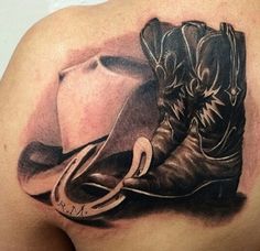 the back of a man's shoulder with a cowboy hat and boots on it