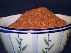 a bowl filled with brown sugar sitting on top of a table